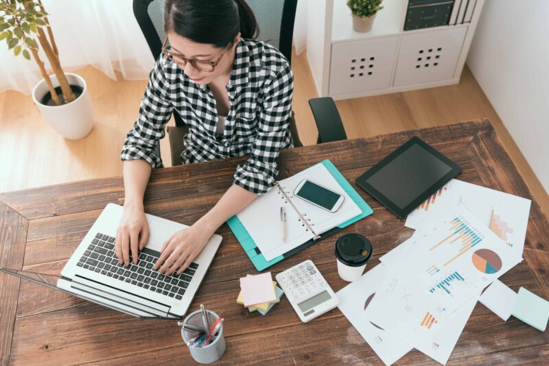 high angle view photo of professional elegant office worker woman typing on mobile computer to making work report when she working at home.