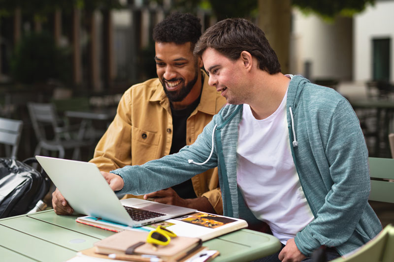 2 men looking at a computer