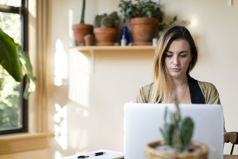 woman looking at computer in her office