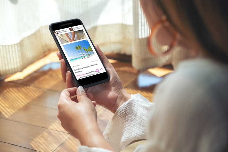 woman on phone reading the hollywood gossip