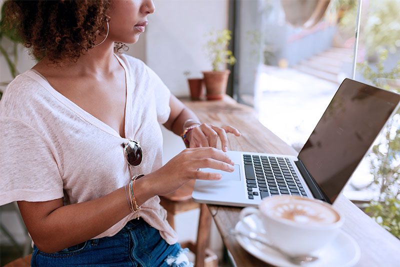 woman using computer at a cafe