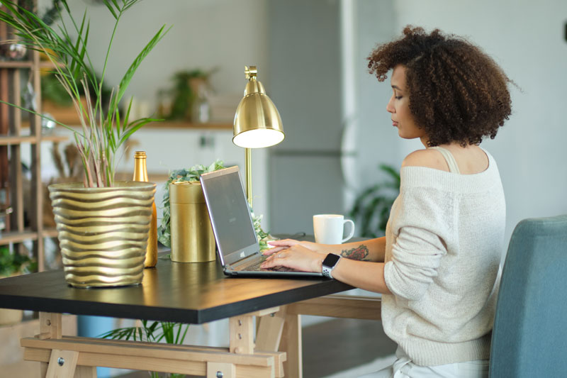 woman using computer at home desk