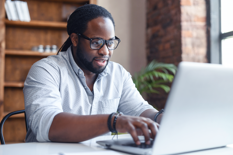 man using laptop in a home office